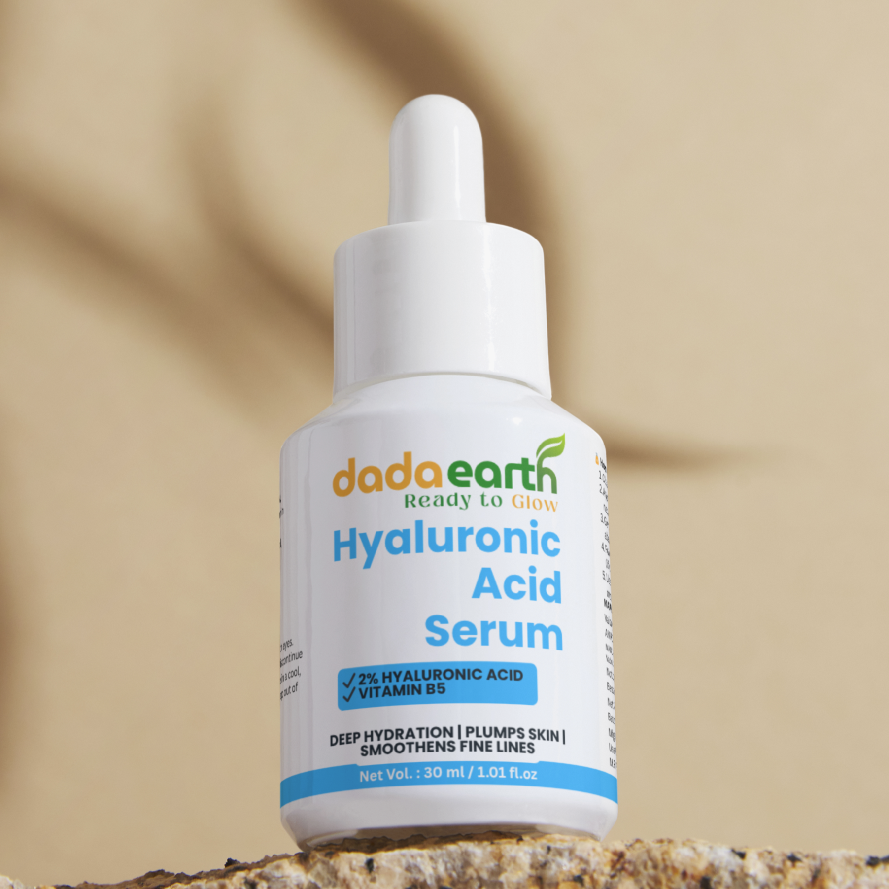 Bottle of Dada Earth Hyaluronic Acid Serum on a stone surface with a beige background