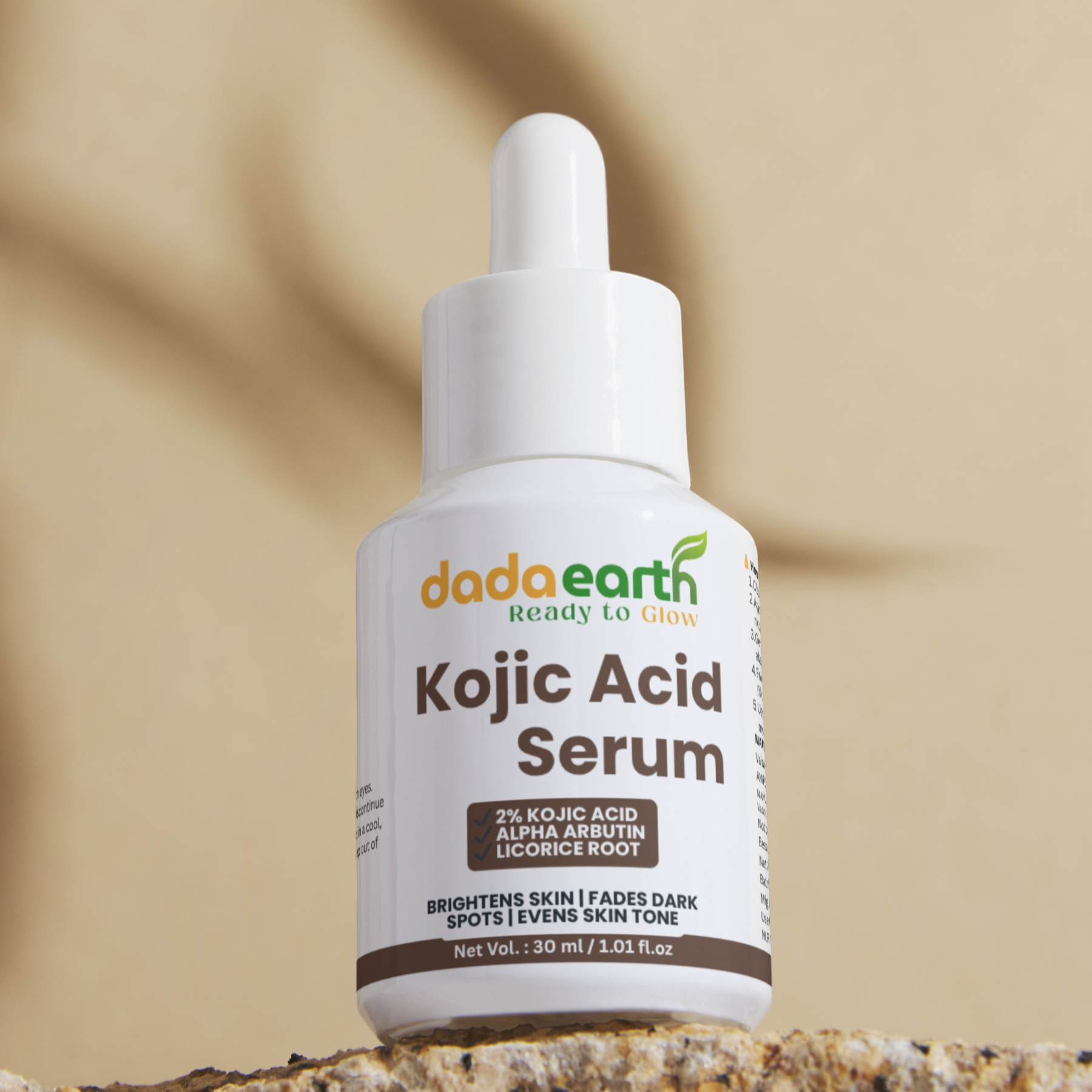 Dada Earth Kojic Acid Serum bottle on a stone surface with a beige background
