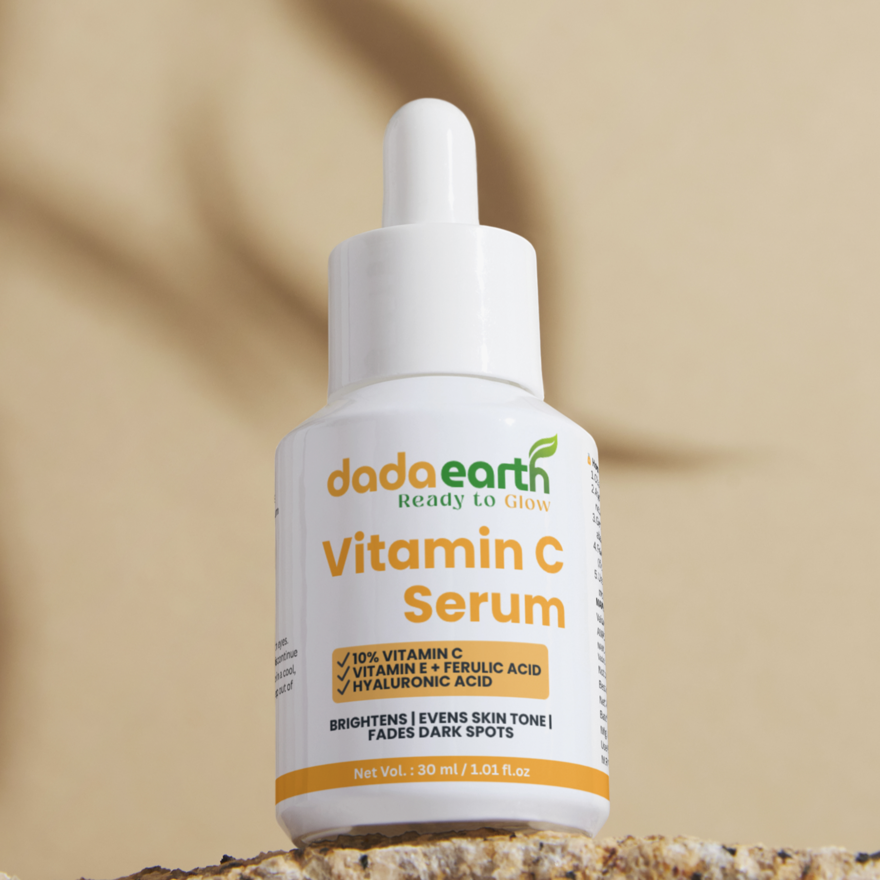 Dada Earth Vitamin C Serum bottle on a stone surface with a beige background